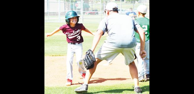 Clinton Maroon’s Snider Dowdell, left, hit the walk-off single to right and celebrated accordingly, sprinting to the mound to celebrate with his coach and father, Ernie. Clinton survived the first wave of eliminations to make it to day three of state. Article Image Alt Text