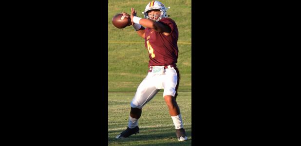 Clinton quarterback Gage Gaunt scans the field in the first quarter of the Reds' 31-12 win over Lawton MacArthur. Gage Gaunt
