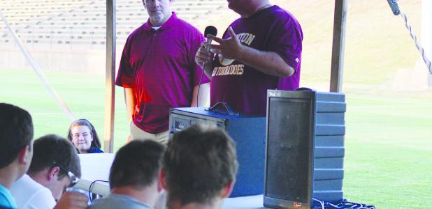 CDN | Andrew Kennedy Co-athletic director Mike Lee (right) introduces CHS football head coach Philip Koons (left) during the Meet the Players picnic Thursday night at the Tornado Bowl.