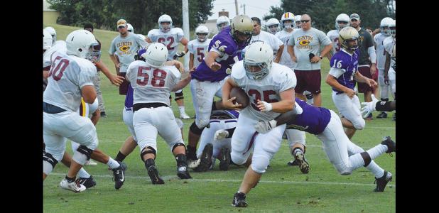 CDN | Fullback A.J. Armbruster bursts through a hole while Bo Felch (50) and Hector Hernandez (58) provide blocks in varisty action from Thursday’s scrimmage against Chickasha.