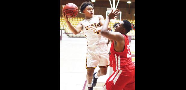 Clinton senior point guard Gage Gaunt goes up into contact on a layup attempt. Gaunt earned three trips to the free-throw line and sunk all six of his attempts on his way to 11 points against Harding Fine Arts. CDN|Collin Wieder Article Image Alt Text