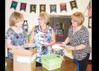 Nance educators (from left) Tricia Meacham, Kathy Brinkley and Kathy Heard unbox books students will use in their classrooms. The first day of the 2016-2017 school year starts today, but Clinton teachers have been back at school preparing since last week. 