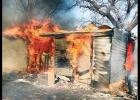 Flames blaze away during a fire Monday in a workshop at former Clinton Fire Chief Forrest Valentine’s home. The workshop was destroyed, and Valentine’s pet dog perished.
