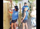 CDN | Robert S. Bryan Williams Energy helped conduct a food drive collecting more than 100 pounds of food for the Mission House. They also donated material and labor to build a fence at the shelter. Shown working on the fence were, from left, Trisha Clothier, Jason Weaver, Graci Heerwald and Chris Ackerman and Mission House director Eva Hecker.