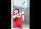 Clinton No. 1 doubles player Blake Wolters reaches up high for a return during tennis practice. Article Image Alt Text