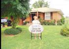 Ana Gonzalez stands on her front lawn at 1209 Santa Fe, with her dog “Palomito.”