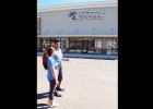 Max and Keaton Modi check out the new sign for the Anytime Fitness location, as they get ready to go inside and survey construction progress.