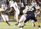  Sophomore running back DayDay Simpkins (No. 24) takes the handoff from junior quarterback Conor Wyer (No. 8). Seniors Zach Acosta (No. 75) and Joseph Roque (No. 44) pave the way for the Reds’ running back. The Reds’ running game racked up 288 yards in the second half alone. They averaged more than 12 yards per carry in the second half.
