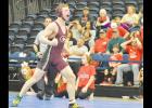 D.J. Craddock celebrates his dual-sealing pin against Fort Gibson Friday night. The Reds trailed 30-26 entering the final weight matchup. Craddock recorded a 1:50 pin to send the Tigers home.