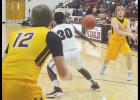  Luke Sewell (right) hits Jackson Cornell (No. 12) with a post entry pass during the Reds’ game against Sayre last Tuesday.